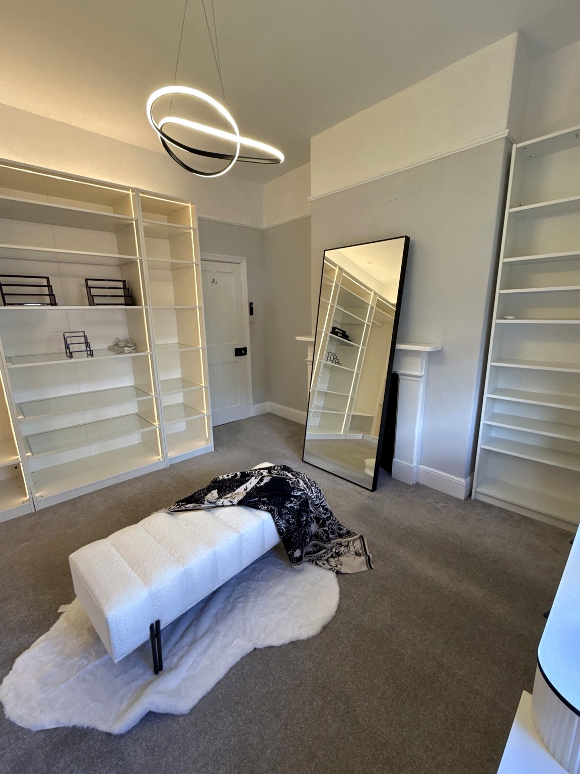 Finished neutral bedroom with layered lighting